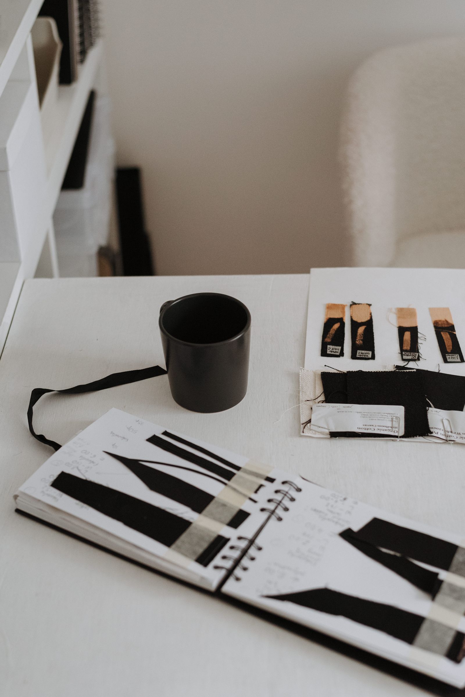 Material samples and design notes on a product development desk